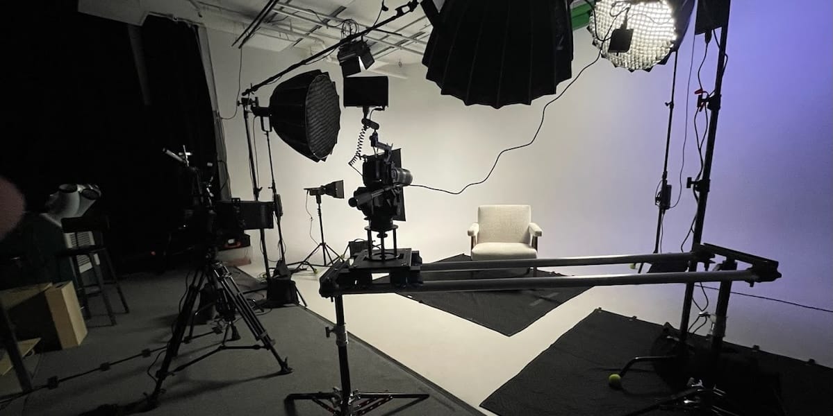 REV Studios crew setting up lighting and camera equipment during a video production shoot