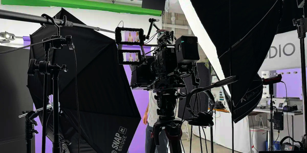 Close-up of camera, lighting, and gear with REV Studios sharing industry tips.